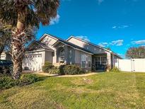 Charming single-story home with lush front lawn and well-maintained landscaping at 2609 Summer Creek Dr, Kissimmee, FL 34747