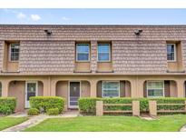 Charming townhouse featuring manicured landscaping, covered entrance and shingled facade at 3104 Harrison Ave # 11, Orlando, FL 32804