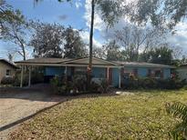 Charming single-story home with a carport and nicely landscaped front yard at 5834 Forest Grove Blvd, Orlando, FL 32808