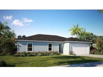 Single-story home with a two-car garage and landscaped lawn at 590 E Division W St, Deland, FL 32724