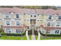 Inviting two-story townhome featuring a terracotta roof, landscaped walkway and charming facade at 980 Mooring Ave # 103, Altamonte Springs, FL 32714