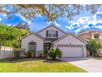 Charming single Gathering home featuring well-maintained landscaping and a paved driveway at 12918 Hunters Vista Blvd, Orlando, FL 32837