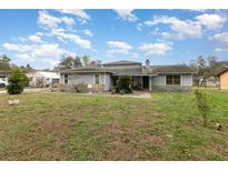 Inviting single-story home featuring stone accents, well-maintained lawn, and ample natural light at 2357 Palm Way, Oviedo, FL 32765