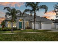 Beautiful two-story home with a teal door and lush landscaping at 2571 Bancroft Blvd, Orlando, FL 32833
