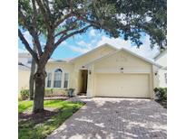 Charming single-story home with a two-car garage and well-maintained landscaping at 124 Lancaster Dr, Davenport, FL 33897