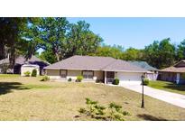 Charming single-story home with well-maintained lawn and landscaping at 18148 Villa City Rd, Groveland, FL 34736