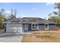 Charming single-story home featuring a two-car garage and well-maintained front yard at 4356 Sw Dahlia Ct, Dunnellon, FL 34431