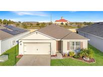 Inviting single-story home with manicured lawn and solar panels for energy efficiency at 651 Tortugas St, Haines City, FL 33844