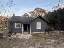 Dark gray house with a small porch and yard at 310 Lake Ave, Dundee, FL 33838
