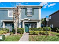 Charming two-story home with a well-maintained lawn and colorful exterior paint at 10421 Manderley Way # 268, Orlando, FL 32829