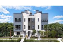 Beautiful new construction townhome with modern architecture, a manicured lawn and lush tropical landscaping at 2221 Valentine Aly, Orlando, FL 32804