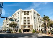 Beautiful exterior view of the white condo building under a bright blue sky at 2305 Edgewater Dr # 1403, Orlando, FL 32804