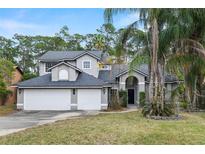 Charming two-story home with a three car garage and well-maintained landscaped yard at 293 Saxony Ct, Winter Springs, FL 32708