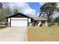 Charming single-story home featuring an attached garage and a well-maintained front lawn at 6855 Galle Ct, Orlando, FL 32818
