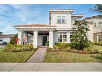 Charming two-story home with a tile roof, landscaped yard, and covered front porch at 10231 Beechwood Ln, Orlando, FL 32832