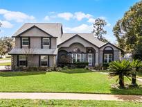 Charming two-story home with landscaped yard and beautiful architectural details in a well-maintained neighborhood at 309 Oakwood Ct, Lake Mary, FL 32746