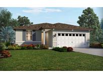 One-story home with a two-car garage and landscaped front yard at 325 Castle Dr, Lake Alfred, FL 33850
