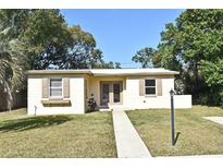 Charming single-story home with a well-maintained lawn and neutral-colored exterior at 878 Rockhill St, Deltona, FL 32725