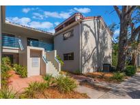 Building exterior with stairs, landscaping, and a walkway at 1000 Winderley Pl # 122, Maitland, FL 32751