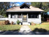 Charming single-story home with a cozy front porch and well-maintained landscaping at 214 E 18Th St, Sanford, FL 32771