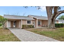 Charming single-story home with a brick-paved walkway, covered porch, and well-maintained landscaping at 4817 Gallant Ln, Orlando, FL 32821