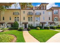 Three-story townhouses with attractive landscaping and walkway at 5409 Napoli Cv, Lake Mary, FL 32746