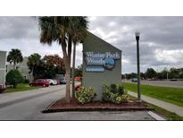 Winter Park Woods Condominium entrance sign with landscaping and parking at 116 Scottsdale Sq # 2, Winter Park, FL 32792