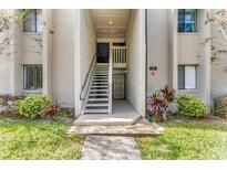 Condo entrance with stairs, well-maintained landscaping and unit number clearly displayed at 134 Springwood Cir # A, Longwood, FL 32750