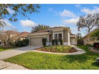 Charming single-story home with well-manicured lawn and neutral colored exterior at 329 Streamview Way, Winter Springs, FL 32708