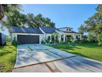 Charming home with a well-manicured lawn, concrete driveway, and an attached garage at 441 Spoonbill Ct, Kenansville, FL 34739