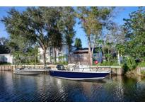 Waterfront property features a private dock and boat lift on a canal leading to open water at 441 Spoonbill Ct, Kenansville, FL 34739