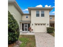 Charming two-story townhome with a well-manicured lawn and attached garage at 5409 Caramella Dr, Orlando, FL 32829