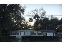 Charming single-story home with a mix of brick and siding facade and a well-kept front yard at 112 Edwards St, Daytona Beach, FL 32117