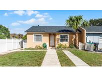 Charming single-story home with well-maintained lawn, palm tree, and white picket fence at 2321 Rio Pinar Lakes Blvd, Orlando, FL 32822