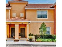 Charming two-story townhome with a terracotta tile roof and well-maintained landscaping at 2943 Banana Palm Dr, Kissimmee, FL 34747