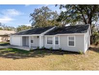 Charming single-story home with well-maintained lawn and attached one-car garage at 6356 Sleepy Hollow Dr, Orlando, FL 32810
