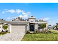 Beautiful single-story home with neutral paint, manicured lawn, and a two car garage at 8456 Norwich Way, Mount Dora, FL 32757