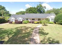 Charming single-story home featuring a well-manicured lawn and beautiful landscaping at 1108 Bahama Dr, Orlando, FL 32806