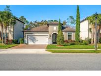 Charming one-story home features a manicured front yard, brick driveway, and a two-car garage at 1208 Patterson Ter, Lake Mary, FL 32746