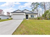 Charming single-story home with a well-maintained lawn, two-car garage, and inviting curb appeal at 1660 5 Ave, Deland, FL 32724