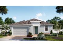 Charming single-story home featuring a gray exterior, well-manicured lawn, and attached two-car garage at 1768 Columbus Path, St Cloud, FL 34771