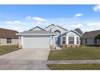 Charming single-Gathering home featuring a well-maintained lawn and attached two-car garage at 8523 Fort Clinch Ave, Orlando, FL 32822