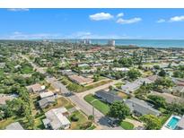 Expansive aerial view showcasing a residential area with ocean views and modern buildings in the distance at 867 N Halifax Dr, Ormond Beach, FL 32176