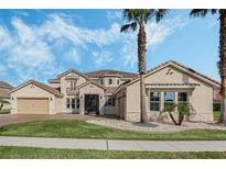 Stunning two-story home featuring manicured lawn, stone accents, and a barrel tile roof at 1191 Terralago Way, Kissimmee, FL 34746