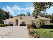 Charming single-story home featuring a spacious driveway, manicured landscaping and a 3-car garage at 126 Seville Chase Dr, Winter Springs, FL 32708
