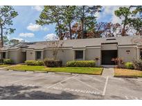 Charming condo exterior with well-maintained landscaping and reserved parking spaces at 133 Springwood Cir # A, Longwood, FL 32750