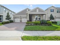 Charming home with a well-maintained lawn, three-car garage, and brick-paved driveway at 17858 Adrift Rd, Winter Garden, FL 34787