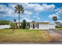 Charming single-story home with a well-maintained lawn and tropical landscaping at 198 Benjamin Dr, Ormond Beach, FL 32176