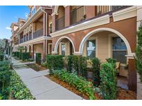 Charming townhome with beautiful landscaping, stucco, arched doorways, and balcony at 3321 Messina Dr, Lake Mary, FL 32746