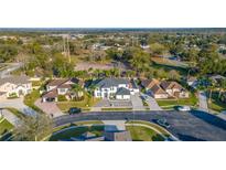 Aerial view of the property showing the house, driveway, landscaping, and surrounding neighborhood at 352 Radisson Pl, Oviedo, FL 32765